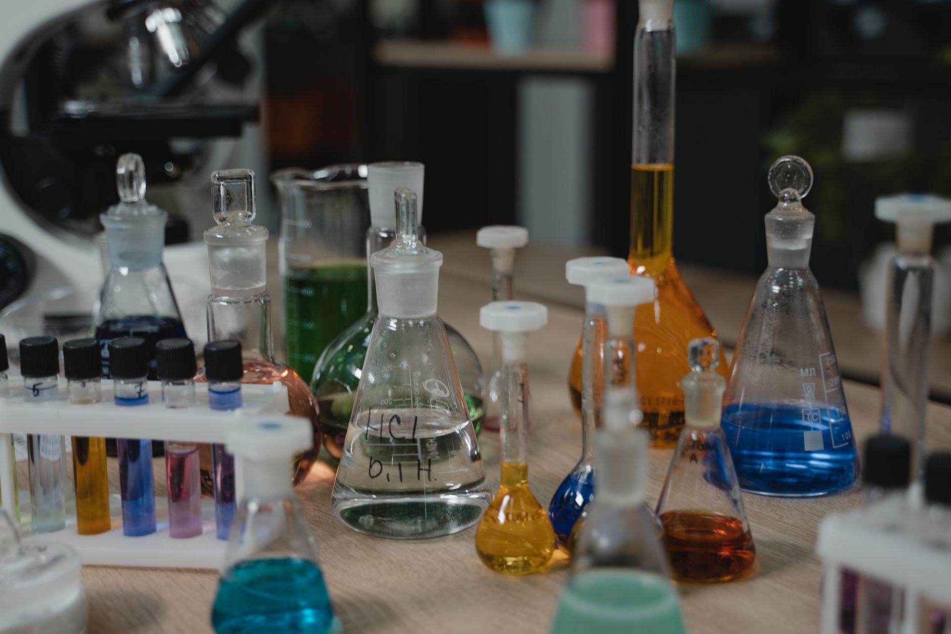 Laboratory technician testing cosmetic product samples for chemical residue under bright lab lighting